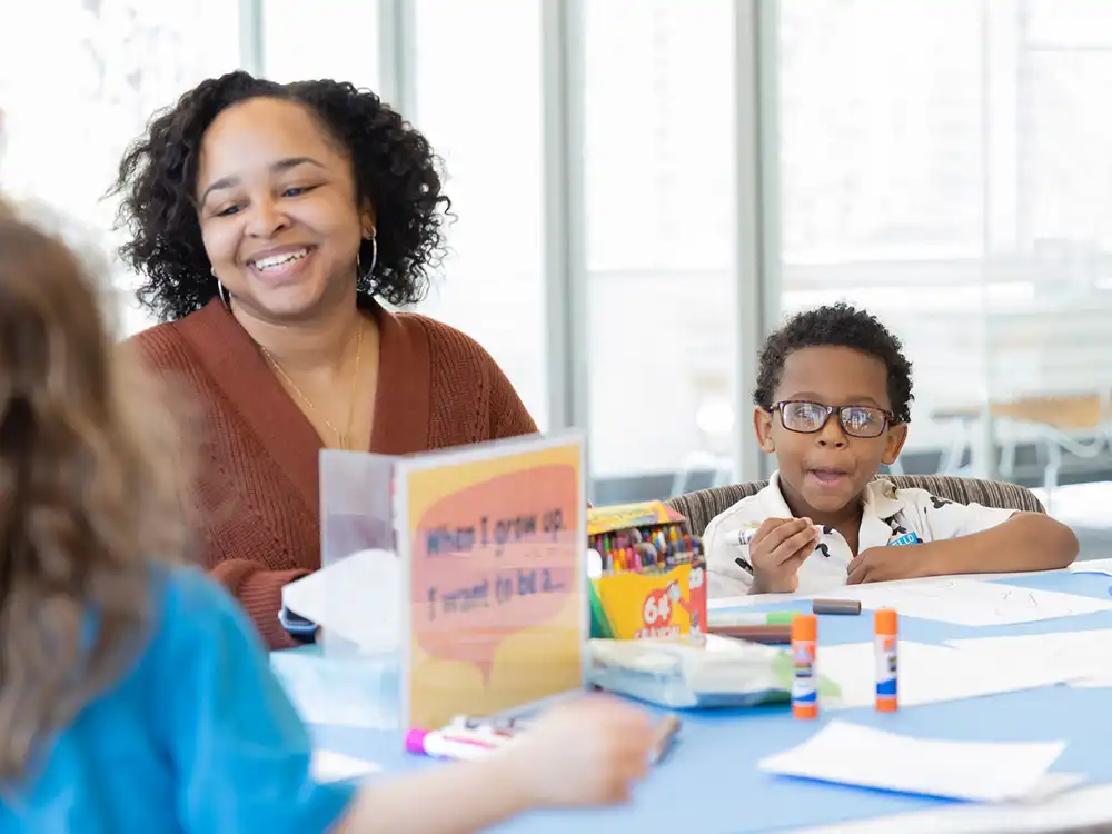 An educator and children doing crafts together