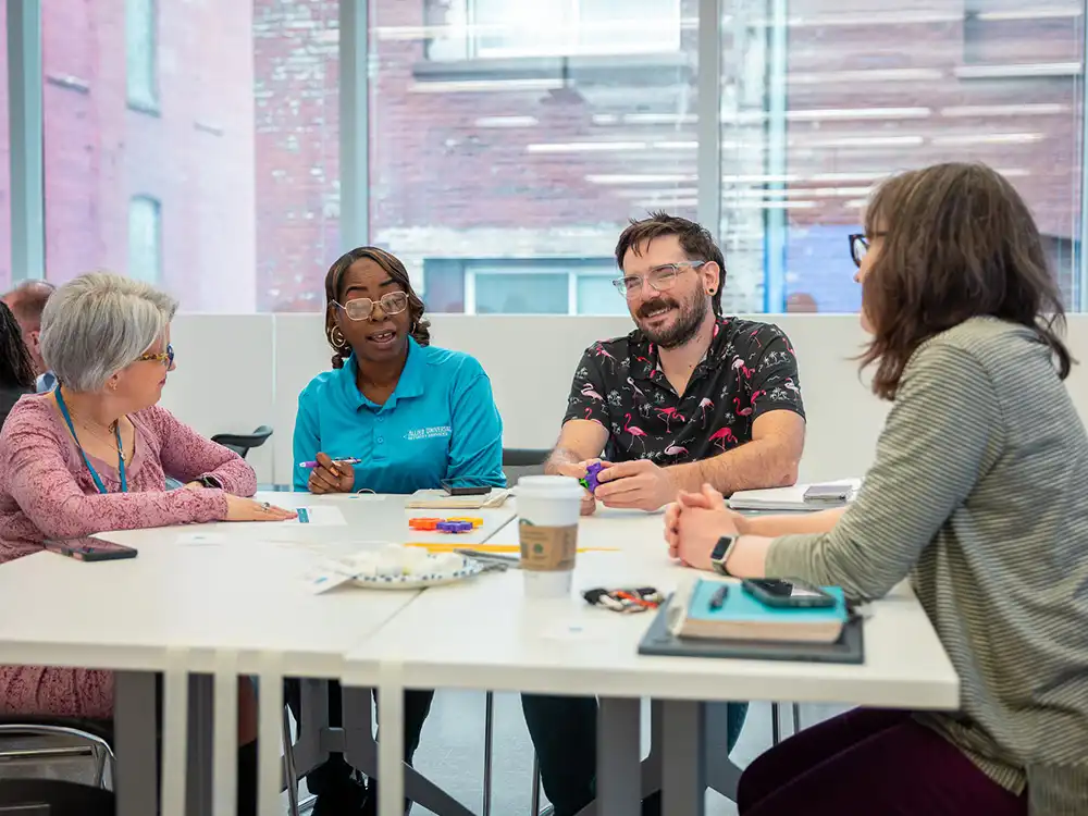 Educators having a conversations around a table