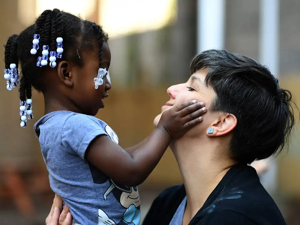 A woman holding a child