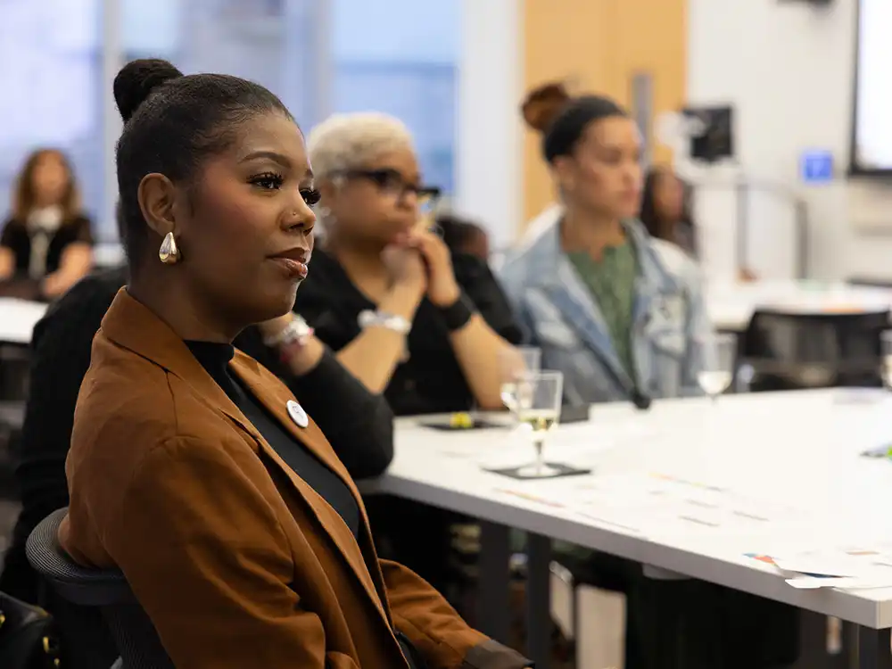 Educators sitting at a table listening